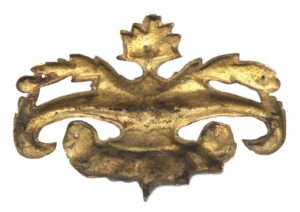 Ornate antique bronze applique with a central urn and leaf-like scrollwork, shown front view.