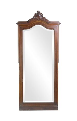 Tall wood mirror with an arched top and ornate Rococo carving, shown front-facing with a full-length beveled mirror and dark wood frame.