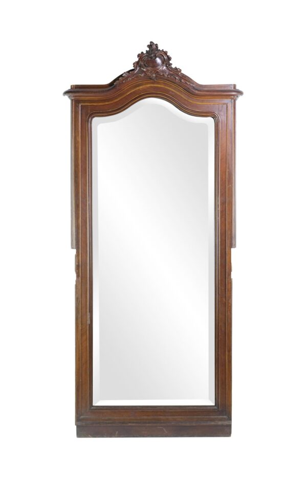 Tall wood mirror with an arched top and ornate Rococo carving, shown front-facing with a full-length beveled mirror and dark wood frame.