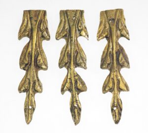 Set of three antique bronze leaf appliques with a vertical stem and mounting holes, shown front view.