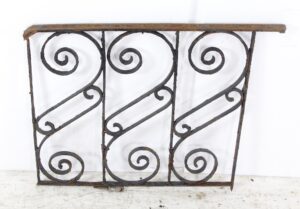 Antique wrought iron panel with three spiral scroll sections and a weathered black finish.