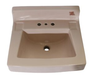 Vintage pink porcelain sink with a rounded trapezoid bowl, three faucet holes, and a central drain opening shown from above.