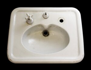 White porcelain sink shown from above with a single basin, two cross handles, one open fixture hole, and a hairline crack near the back center.