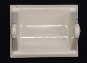 Vintage ceramic flush mount toilet paper holder shown from the front with a rectangular pale yellow face and side supports.