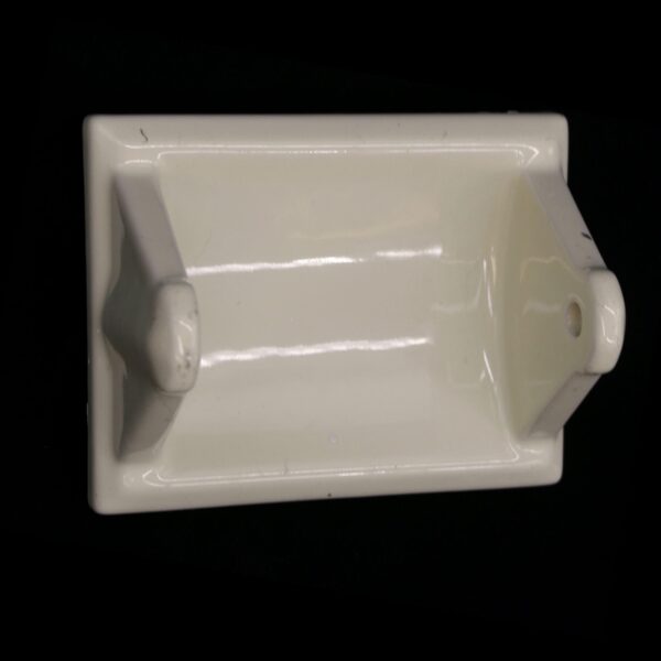 Ceramic flush mount toilet paper holder with a pale yellow porcelain finish, shown from above.