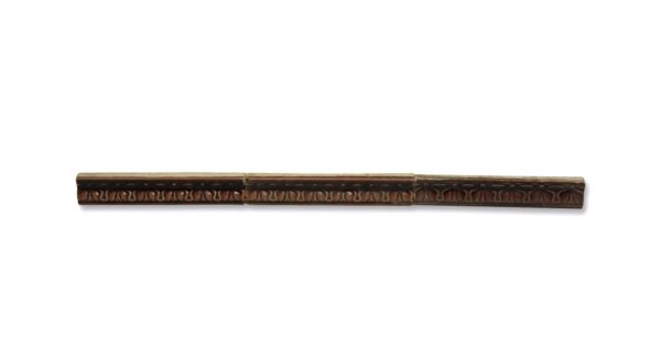 Brown ceramic bull nose trim tile with a floral pattern, shown as a long horizontal piece.