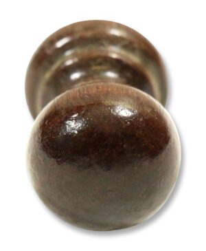 Wooden cabinet knob shown in a close-up front view with a rounded profile and visible screw hole opening behind it.