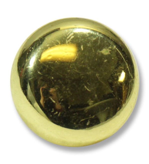 Round brass cabinet knob with a polished finish and visible surface wear, shown in close-up.