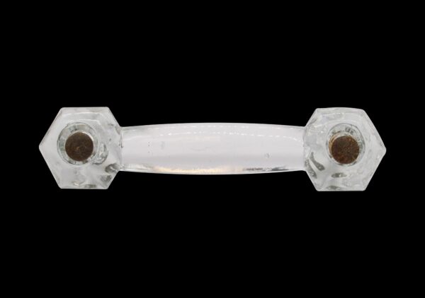 Clear cast glass drawer pull with hexagon ends and a smooth bridge, shown front view with mounting holes visible at both ends.