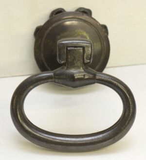 Cast iron drop ring drawer pull with a black finish and mounting plate shown in close-up.