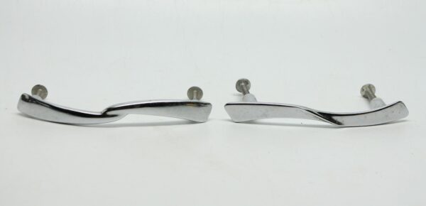 Pair of chrome bridge drawer pulls shown side by side, each with a curved streamlined handle and two screw posts.