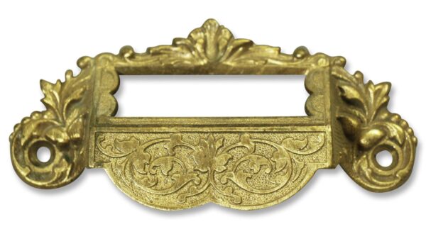 Ornate Victorian cabinet bin pull with a top name slot and decorative scrollwork.
