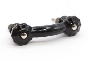 Black glass bridge drawer pull with fluted ends and chrome mounts shown in a close-up view.