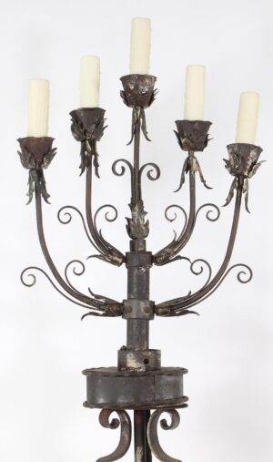 Wrought iron five-light floor candelabra with foliate scrollwork and tapered candle sleeves.