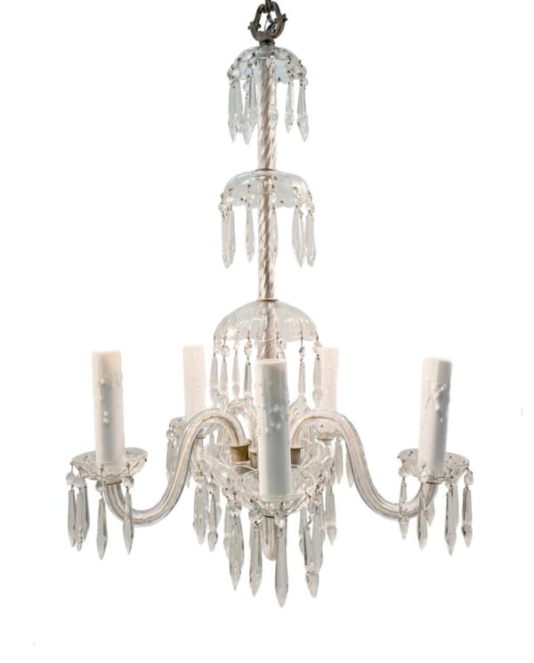 A five-arm chandelier with a twisted glass shaft, clear crystal details, and dangling spear-shaped prisms around candelabra sockets.