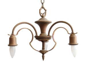 Antique brass three-arm down light chandelier with curved strap arms, bell-shaped sockets, and a chain hanger.