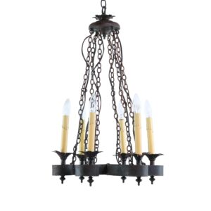 Six-arm black wrought iron candlestick chandelier with hanging chains and candle-style bulbs.