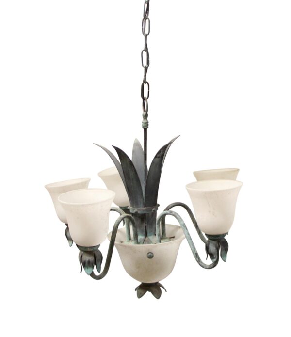A French-style five-arm chandelier with green metal leaves, white frosted glass shades, and a chain suspension.