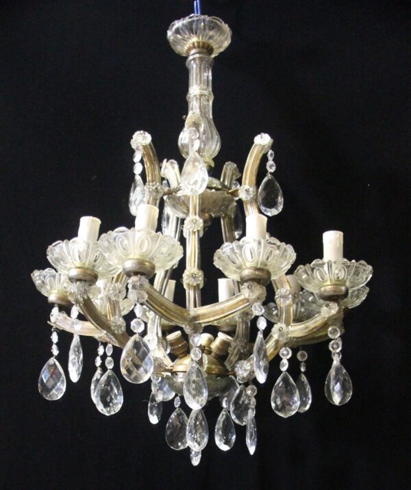 Marie Therese crystal chandelier with 10 scrolling arms, scalloped bobeches, and hanging teardrop prisms.