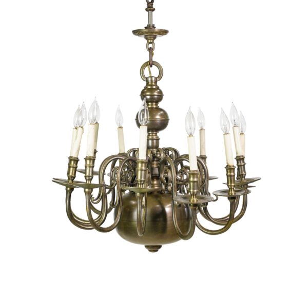 Bronze chandelier with twelve curved candle-style arms, a spherical center, and a baluster stem.