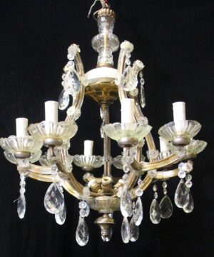 Marie Therese chandelier with 10 scrolling arms, candlestick sockets, and hanging crystal prisms.