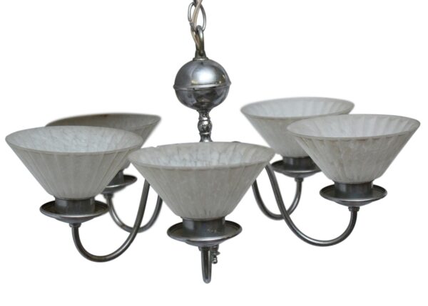 Art Deco five-arm chandelier with a chrome frame and five white slip shades, shown in a close-up view.