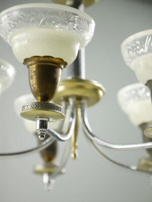 Close-up of a Victorian five-arm chandelier with clear and frosted slip shades and a nickel finish.