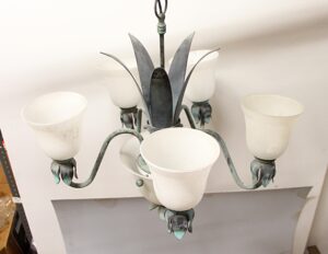 Five-arm French chandelier with frosted white glass shades and a central glass dome finial.