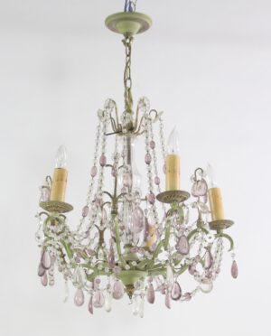 A 1970s chandelier with five arms, clear and amethyst crystal bead strands, teardrop pendants, and candle-style sockets on a muted green frame.