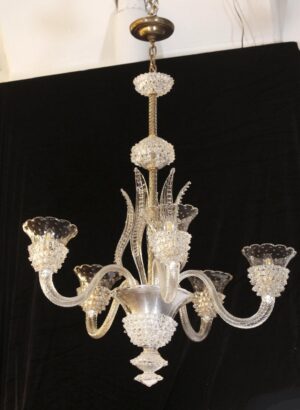 Clear five-arm glass chandelier with S-shaped arms, a brass chain and canopy, and decorative glass bowls and bobeches.