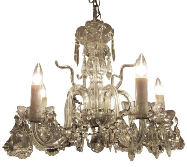Traditional clear glass five-light chandelier with candle-style bulb holders and hanging crystal-like details, shown in a close-up view of the upper portion and arms.