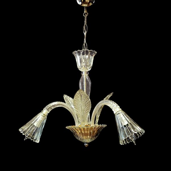 Clear crystal three-arm chandelier with J-shaped arms, leaf details, fluted crown, and bell shades.