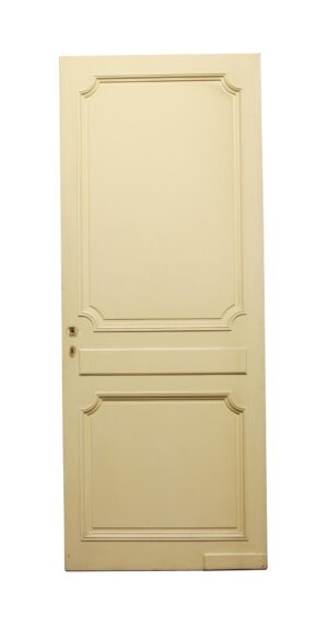 White wooden closet door with two raised panels, rounded edges, and a kick plate.