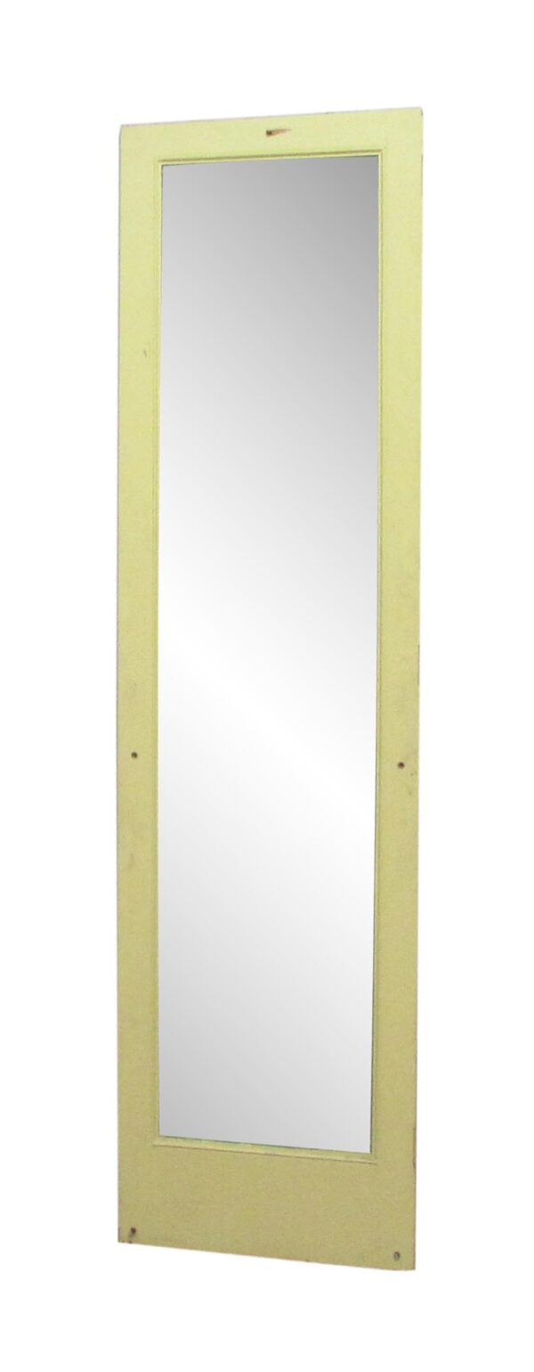 Narrow yellow wood door with a full-length mirror panel.