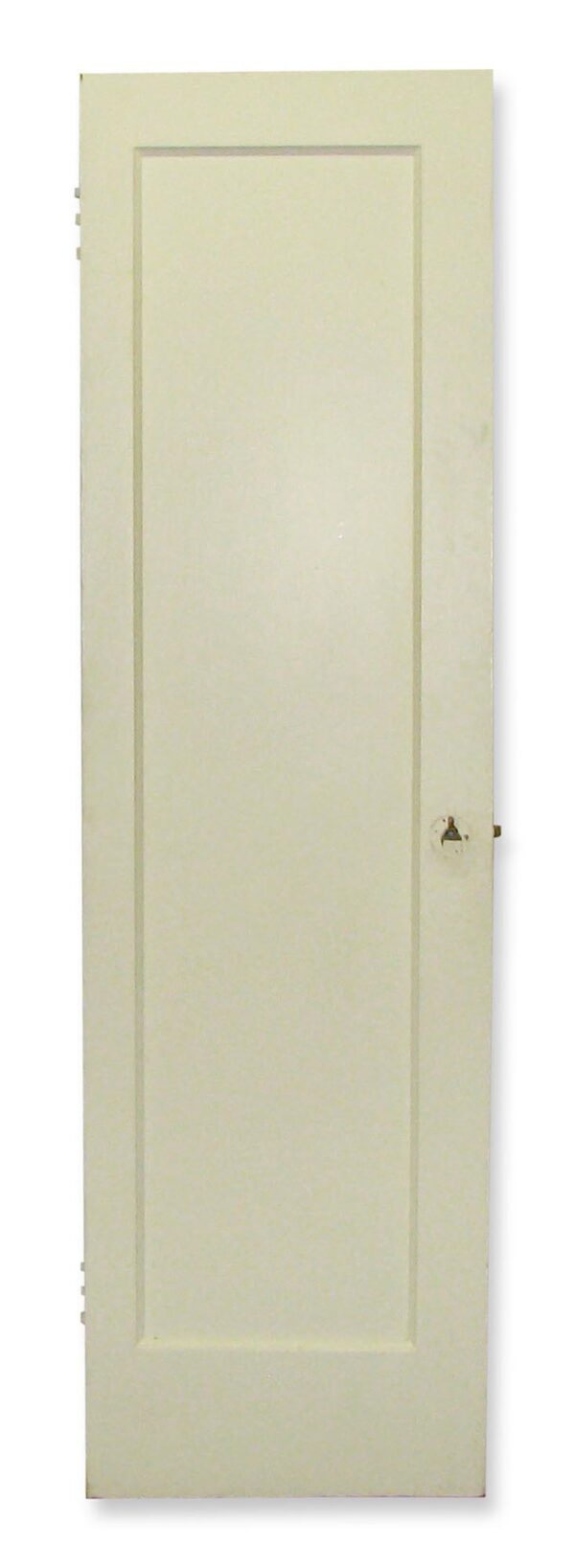 Narrow white wood closet door with one recessed panel visible on this side and hardware holes along the edge.