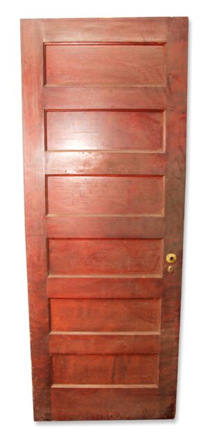 Wooden six-panel closet door shown from the plain side, with a rosette and keyhole plate visible near the right edge.