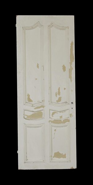 Distressed white six-panel closet door with curved molding accents and peeling paint.