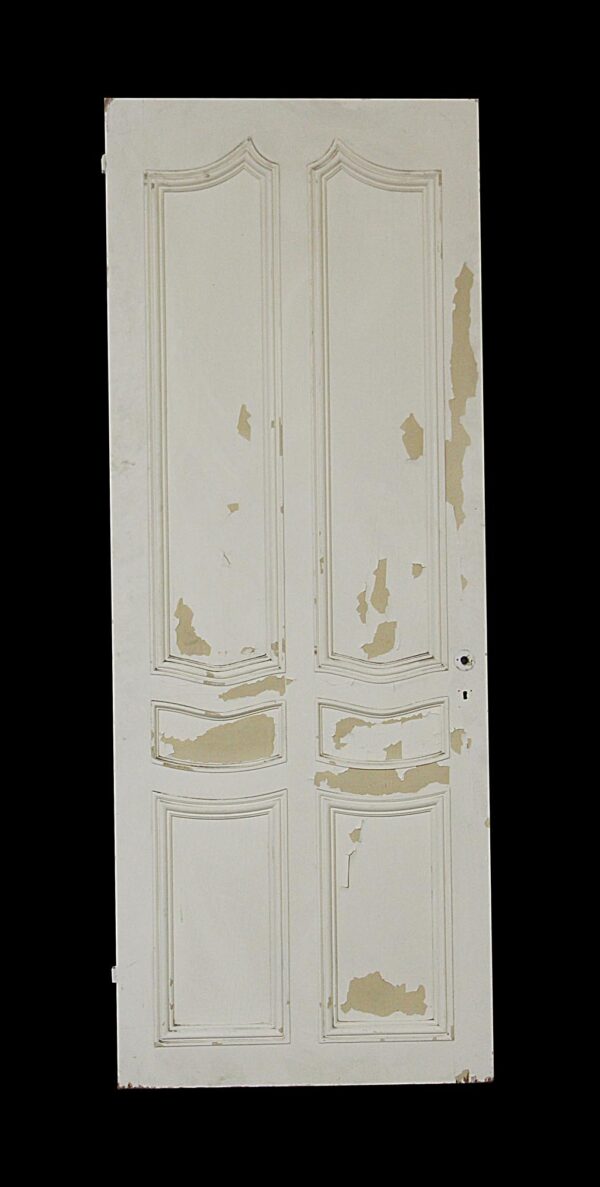 Distressed white six-panel closet door with curved molding accents and peeling paint.