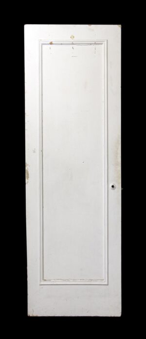 White wooden closet door with one recessed panel and a small knob hole on the right side.