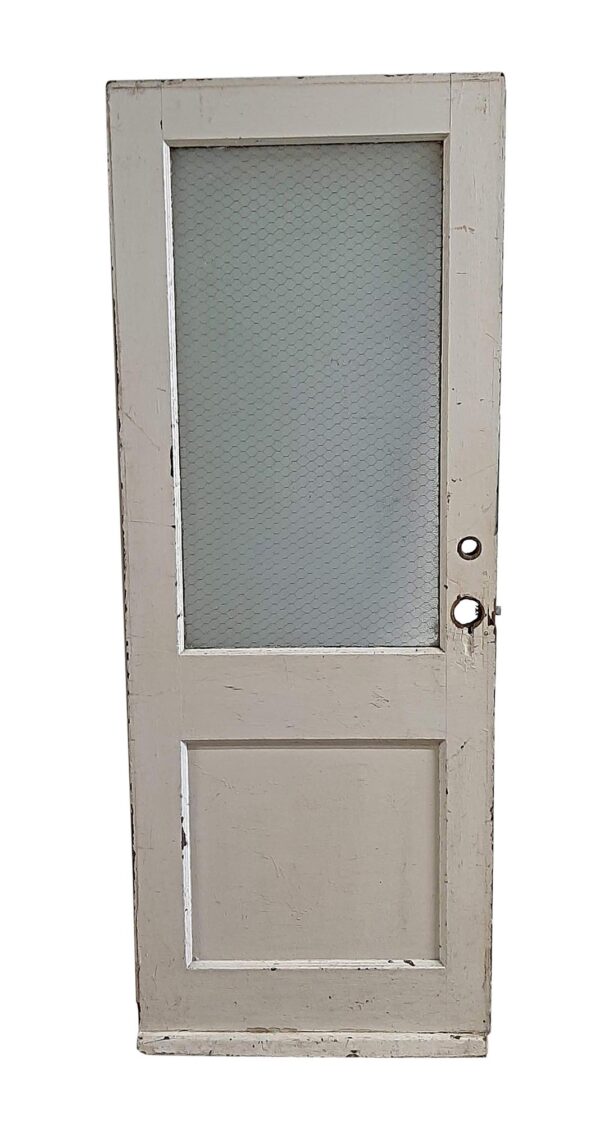 White painted wooden door with one vertical chicken wire glass lite above a solid lower panel and visible hardware holes on the right side.
