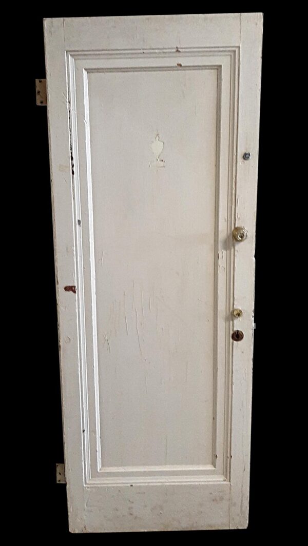 White wooden apartment door with one long recessed panel, shown front-facing with visible hinges and knob holes.