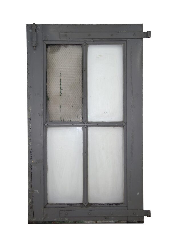 Antique 4-lite metal and zinc window door with one chicken wire pane and three plain panes, shown front view.