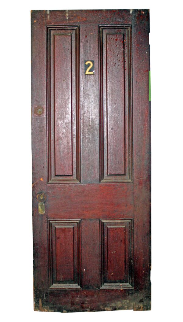 Antique wood apartment door with four panels and a visible number 2 plate near the top.