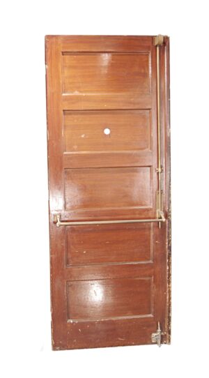 Wooden commercial door with five horizontal panels, a push bar, and visible hardware along the right edge.