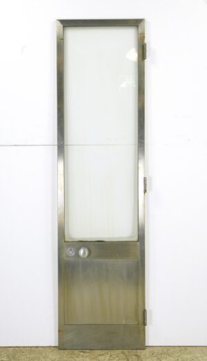 Vintage steel commercial door with a tall glass lite, a bottom panel, cylinder lock, and door knob, shown upright with hinges visible on the right side.