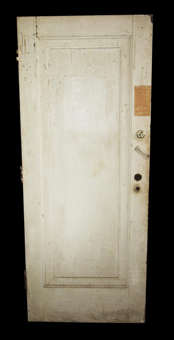 Vintage white wooden apartment door with one panel, shown with original hardware, a peephole, and a mortise set on the right side.