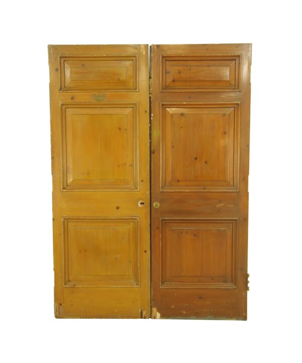 Pair of vintage wood double doors with three panels each, shown front on and joined at the center, with visible wear on the bottom edges.