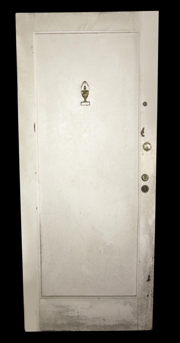 White apartment door with one recessed panel, a peephole, and visible lock hardware on the right edge.