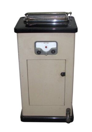 Vintage Ritter sterilizer machine with black and tan metal body, front control panel, and lower access door.