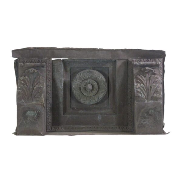 1910s copper cornice section with two carved corbels and a central floral medallion, shown front on with visible verdigris patina.